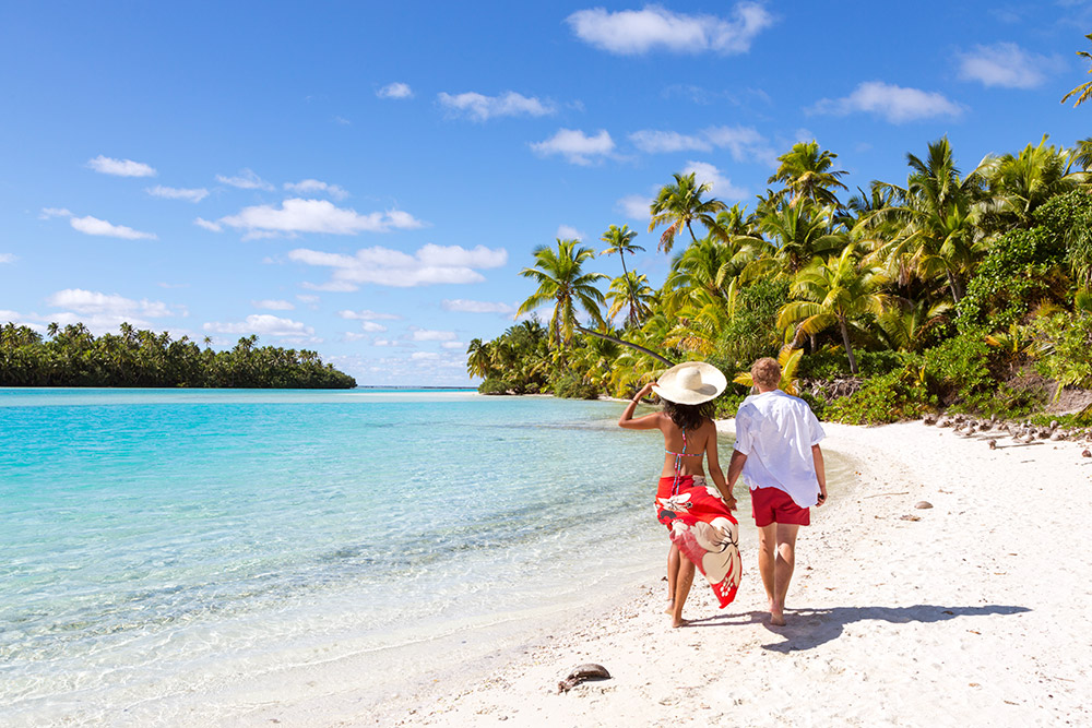 couple on a palm-studded beach