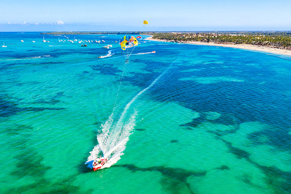 Travelers visit Punta Cana to walk along the sandy shores of Playa Bávaro, one of the most popular beaches in the Dominican Republic