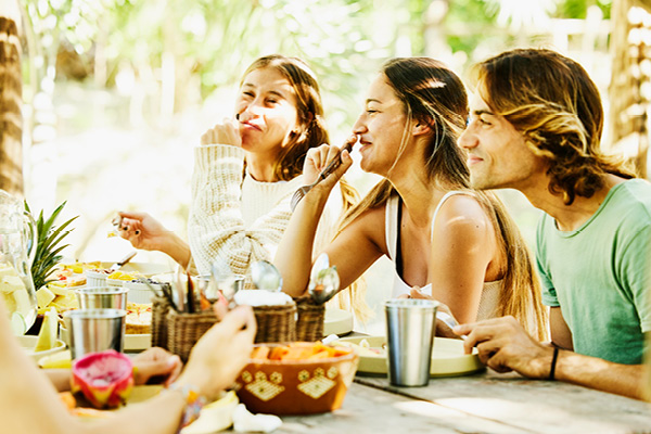 Group of friends enjoying a meal in a tropical setting