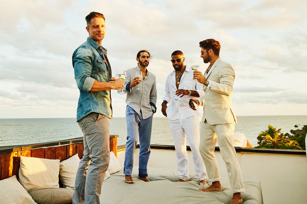 Men and male-identifying destination wedding guests in casual attire