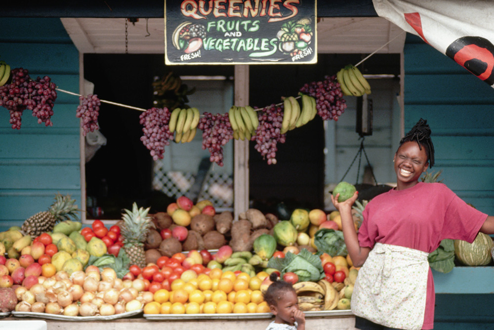 Woman selling fruit at a food stall in The Bahamas