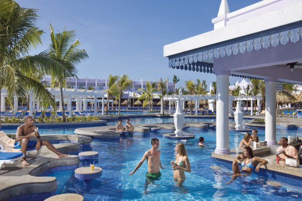 Guests enjoying the pool at Hotel Riu Reggae