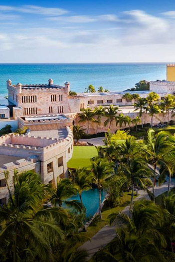 The beautiful Sanctuary Cap Cana resort in the Dominican Republic, featuring its signature castle-style buildings and oceanfront location.