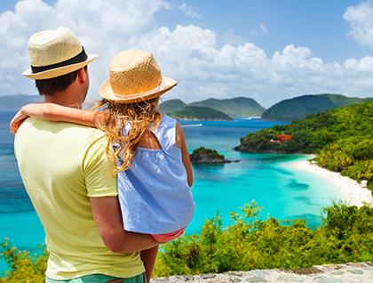 Father and daughter overlooking a Caribbean island