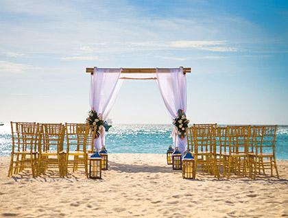 Wedding ceremony setup on the beach during the day