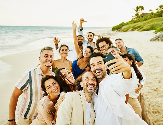 A group takes a selfie on the beach