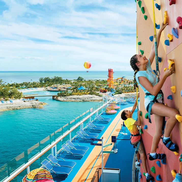 A woman climbs the rock wall on a Royal Caribbean cruise ship