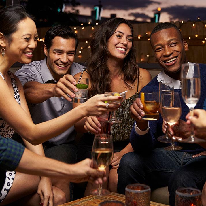 Group of young adults share in a champagne toast on an evening out