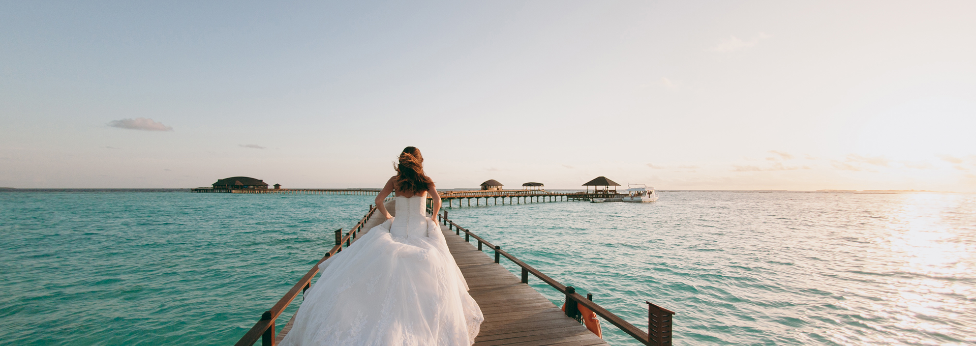 Destination wedding bride on a pier over water