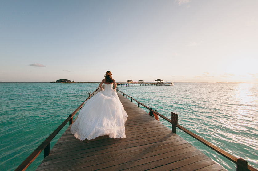 A bride walks on a pier