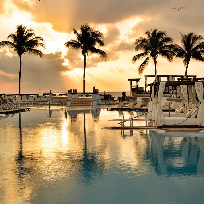A Hilton All-Inclusive resort pool at sunset