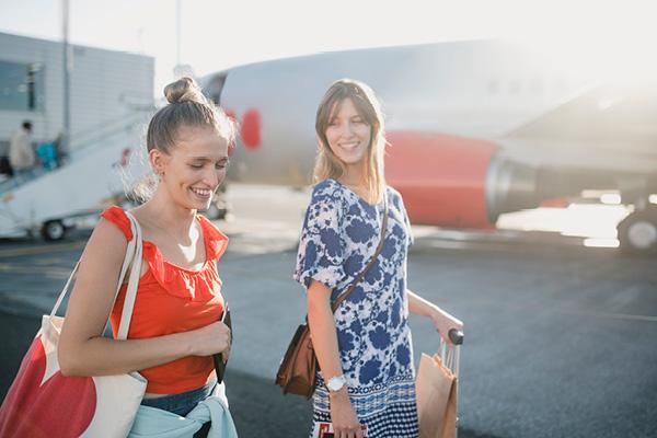 Two women disembarking from plane