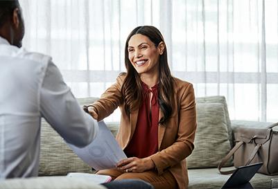 A woman shakes  coworker's hand