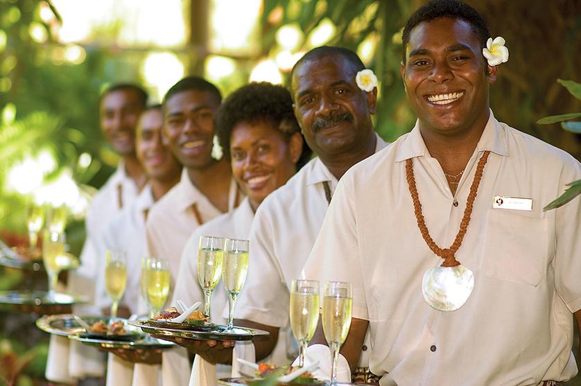 Outrigger Hotels & Resorts staff greeting with champagne