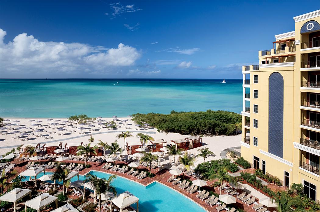 Pristine white sand beach and luxury pool amenities at the Ritz-Carlton Aruba