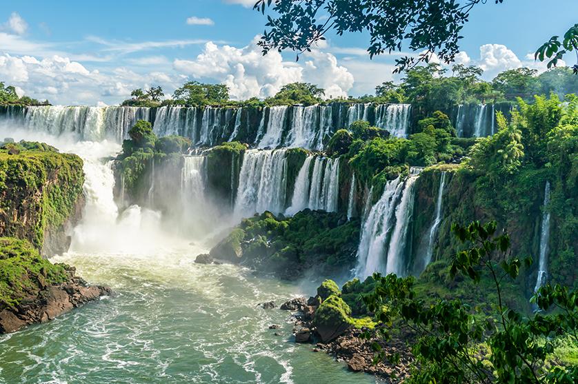 Lush greenery adorn the rocks in the Iguazu Falls waterfall in South America