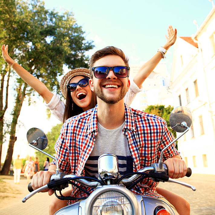 A man and woman enjoying a fun motorized scooter ride